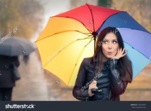 stock-photo-surprised-autumn-woman-holding-rainbow-umbrella-funny-fall-girl-wearing-leather-jacket-outside-318234365