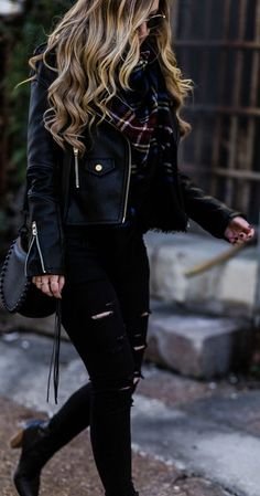 All black winter outfit styled with black leather jacket, black distressed jeans, plaid blanket scarf, and black ankle booties